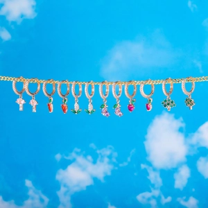 Golden hoop earrings with nature-themed vegetable charms and colorful crystals