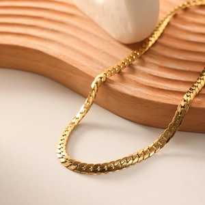 Minimalist 18k gold plated stainless steel flat snake chain necklace on wooden tray