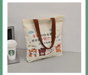 Detail of canvas tote bag featuring cute cartoon animals and motivational Chinese slogans