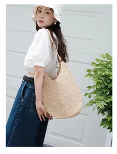 Large raffia woven hobo bag for women featuring natural straw texture and casual style