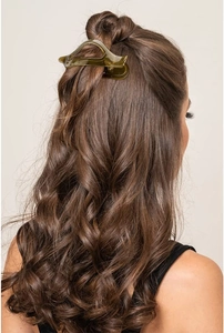 Translucent green claw clip shown in a professional hairstyle on a model