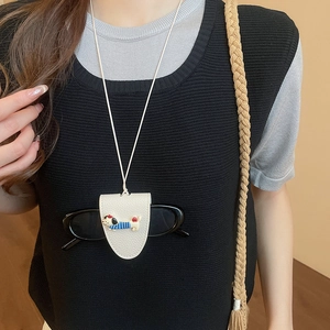 Chic cream leather dachshund glasses holder necklace worn as a fashion accessory