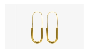 Macro view of long U-shaped gold earrings with polished finish and thick tube design