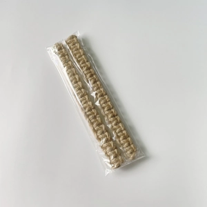 Detailed macro view of bohemian hand-woven jute curtain tiebacks in clear plastic packaging