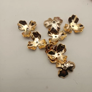 Detailed view of golden flower-shaped metal accessories for DIY wedding jewelry