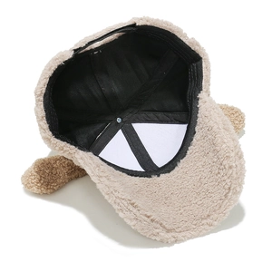 Detail view showing black twill lining and internal stitching of the plush puppy baseball cap