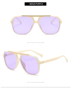 Detail view of beige pilot sunglasses with purple lenses and glossy plastic frame structure