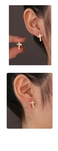 Detail of 14K gold plated cross hoop earrings with sparkling cubic zirconia on model
