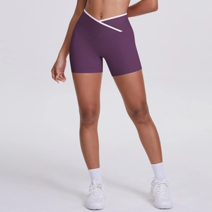 Close-up of high-waisted yoga shorts with white V-shaped crossover waistband contrast