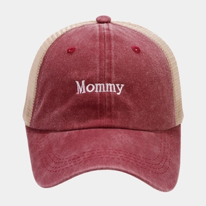 Detail of red vintage washed cotton baseball cap featuring white Mommy embroidery and mesh back