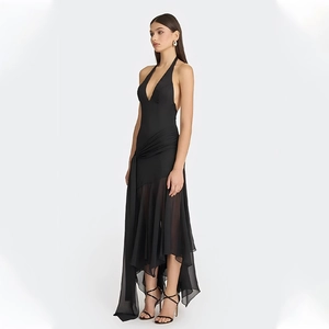 Detail of multi-layered sheer tulle skirt with asymmetric hem on black halter neck dress
