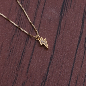 Detail of lightning bolt pendant necklace with clear zircon stones on gold box chain