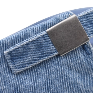 Detail of adjustable metal buckle and washed denim texture on classic baseball cap