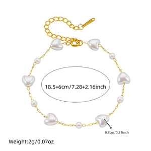 Golden stainless steel chain bracelet with white heart beads and pearls on white background