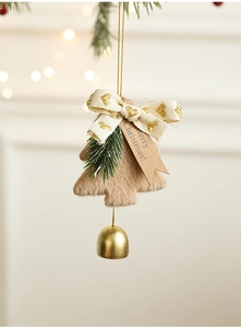 Detail of Christmas plush bell ornament with brown fur, gold bell and Merry Christmas tag