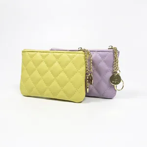 Quilted faux leather coin purse set in yellow and purple with gold chain hardware