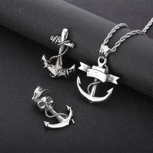 Close-up of vintage punk stainless steel anchors and skull pendant charms for men