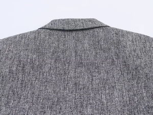 Detail of grey tweed fabric texture and back neckline stitching on the casual blazer