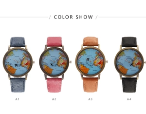 Close-up of world map watch dial with airplane hands and denim leather straps in four colors
