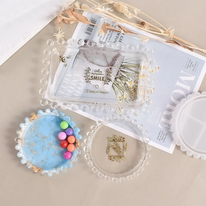 Flat lay of DIY silicone molds for rectangle and round beaded edge jewelry storage trays
