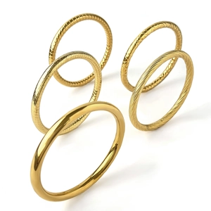5-piece gold titanium steel ring set featuring smooth hammered and textured finishes