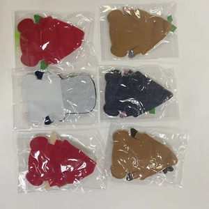 Close-up of assorted colorful felt gnome-themed utensil holders in protective packaging