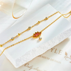 Elegant gold lotus pendant anklet with pink enamel and crystals on white marble