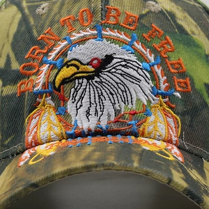 Close-up of eagle embroidery and Born To Be Free text on camo baseball cap