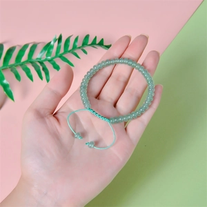 Adjustable hand-woven natural green stone bead bracelet with pull-string closure detail