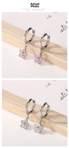 Detail of pink and clear zircon flower drop earrings on silver stainless steel hoops