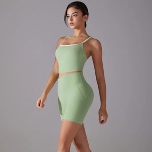 Sage green seamless yoga set with thin strap sports bra and high waisted shorts for fitness