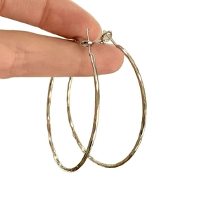 Silver textured large hoop earrings with a hammered finish for a stylish bridal look