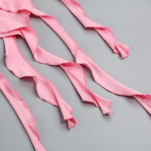 Macro shot of pink ruffled fabric edges showing detailed stitching and soft chiffon texture