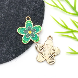 Macro detail of enamel flower charm showing colorful petals and golden metal texture