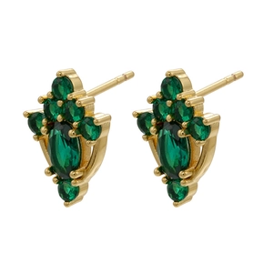 Macro shot of gold vintage earrings featuring micro-set emerald green zircon stones