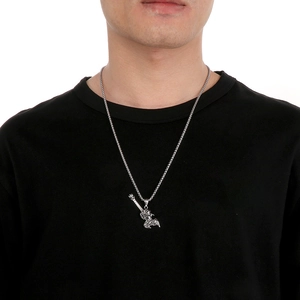 Close-up of a silver winged figure pendant on a woven titanium steel chain for men