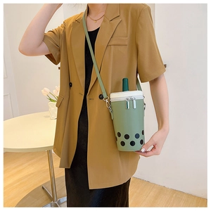 Detailed view of a mint green boba tea shaped crossbody bag featuring a straw top