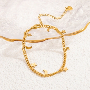 Detail of 18k gold plated stainless steel anklet with star and moon charms