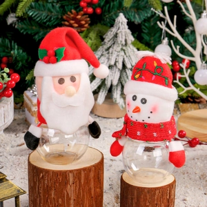 Christmas snowman and Santa candy jars with transparent base on festive holiday background