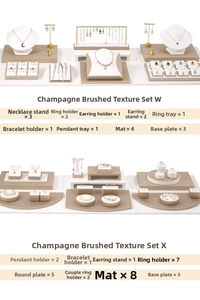 Macro view of champagne brushed texture jewelry display set with multi-component trays