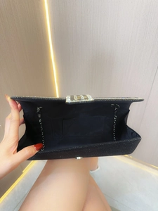 Black glitter evening clutch bag with rhinestone clasp and silver chain strap interior view