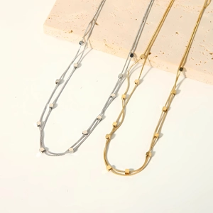 Double-layered 18k gold plated stainless steel necklace featuring small geometric square beads