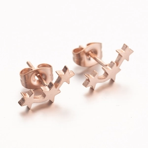 Minimalist rose gold star stud earrings with three stars in a curved layout