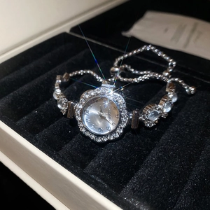 Macro shot of sparkling silver flower-shaped rhinestone watch face and adjustable bracelet