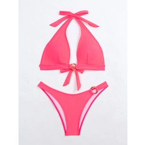 Detail of neon pink halter bikini set featuring metallic ring accents and high-waist cut