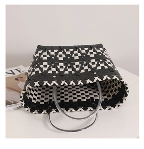 Top view of woven tote bag showing black and white checkered pattern and clear round handles