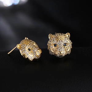Tiger head stud earrings in 18K gold plated copper with pavé cubic zirconia and blue eyes
