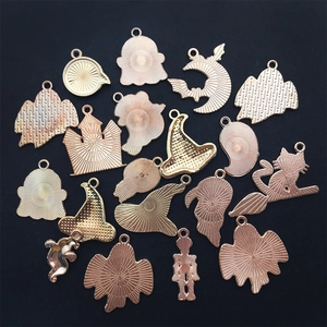Macro shot of assorted golden metal Halloween charms showing textured back patterns