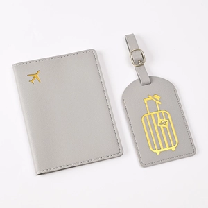 Detail of grey PU leather passport cover and luggage tag with gold foil travel patterns