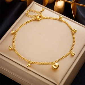 Elegant gold plated stainless steel anklet with polished metal spheres on a display box